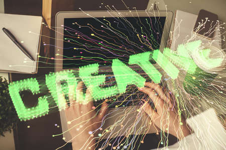 Double exposure of woman hands typing on computer and creative drawing. Start up concept.の写真素材