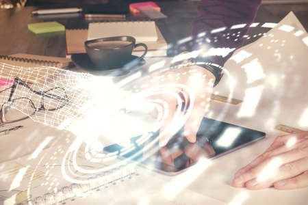 Double exposure of man's hand holding and using a digital device and data theme drawing. Technology concept.の写真素材
