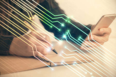Double exposure of technology sketch hologram and woman holding and using a mobile device.
