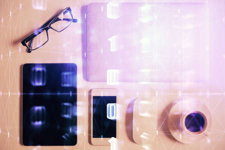 Double exposure of technology theme drawing over work table desktop. Top view. Global data analysis...