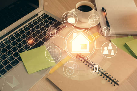 Double exposure of buildings drawing and desktop with coffee and items on table background. Concept of smart cityの写真素材