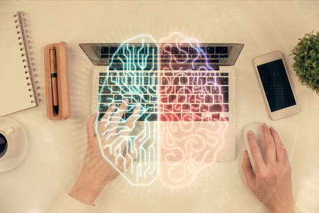 Double exposure of woman working on computer andhuman brain hologram drawing. Top View. Ai concept.