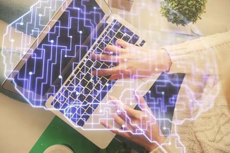 Double exposure of woman working on computer andhuman brain hologram drawing. Top View. Ai concept.の写真素材