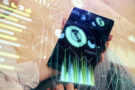 Double exposure of man's hand holding and using a digital device and data theme drawing. Technology...