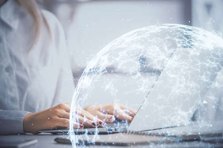 Double exposure of woman hands typing on computer and social network theme hologram drawing. People...