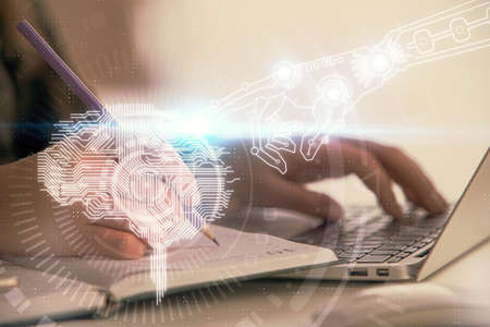 Multi exposure of woman hands working on computer and human brain hologram drawing. Ai tech concept.