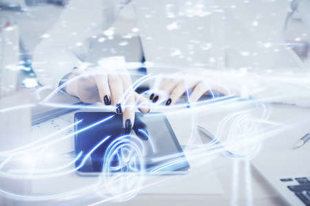 Double exposure of automobile icon hologram and woman holding and using a mobile device. Technology concept.の写真素材