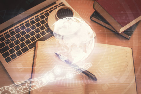 Double exposure of map hologram drawing over study table background with computer. Concept of international network. Top view.の写真素材