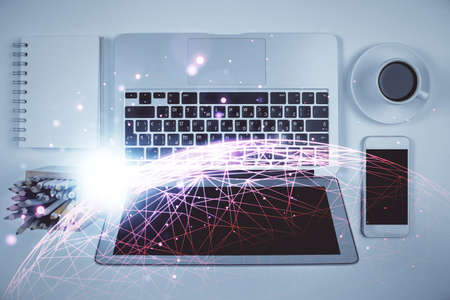 Social network hologram drawings over computer on the desktop background. Top view. Double exposure.