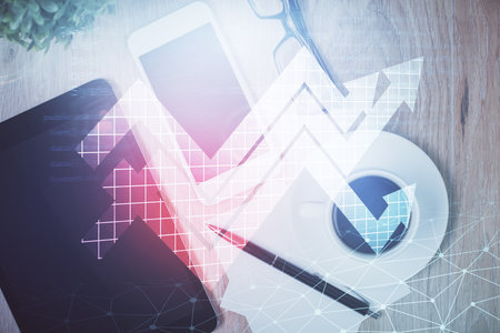 Double exposure of drawing arrows over table with phone. Top view. Growth concept.の写真素材