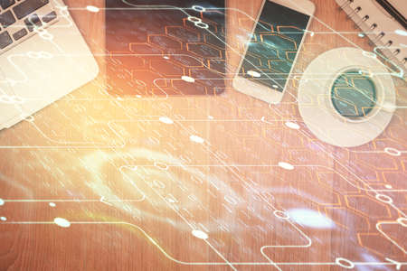 Double exposure of technology theme drawing over work table desktop. Top view. Global data analysis...