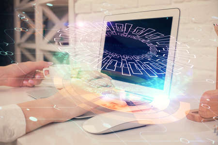 Double exposure of woman hands working on computer and data theme hologram drawing. Tech concept.の写真素材