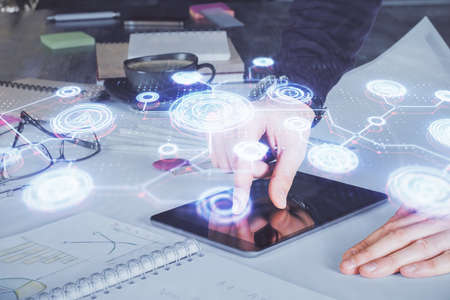 Double exposure of man's hands holding and using a phone and social network theme drawing.