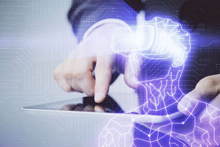 Double exposure of man's hands holding and using a digital device and AR glasses drawing. Virtual...