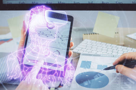 Double exposure of man's hands holding and using a digital device and AR glasses drawing. Virtual...