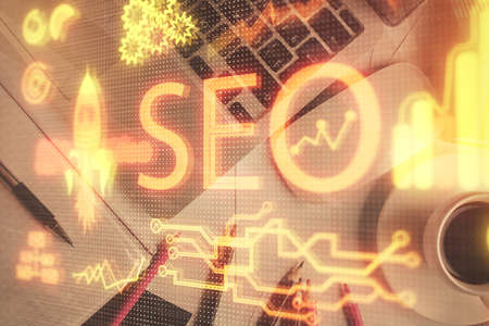 Double exposure of SEO drawing over study table background with computer. Concept of search. Top view.の写真素材