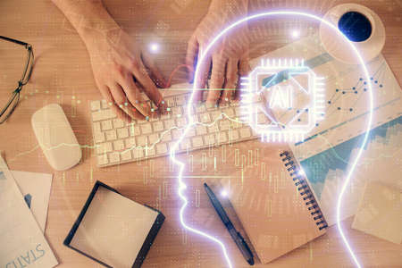 Double exposure of man's hands typing over computer keyboard and brain hologram drawing. Top view....
