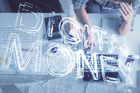 Double exposure of man and woman working together and crypto theme hologram drawing. Computer background. Blockchain concept. Top View.の写真素材