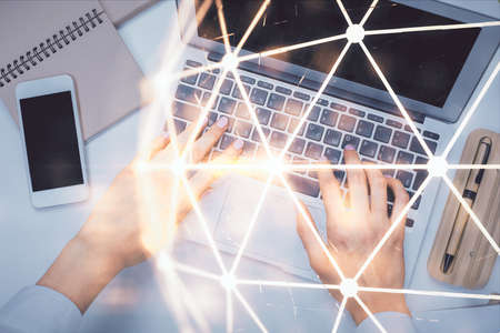 Double exposure of woman hands working on computer and social network theme hologram drawing. Top View. People connection concept.の写真素材