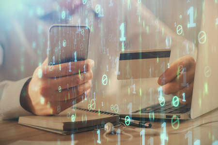 Double exposure of man hands holding a credit card and data theme drawing. E-commerce and technology...