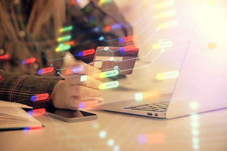 Double exposure of woman on-line shopping holding a credit card and data theme hologram drawing. E-commerce concept.の写真素材