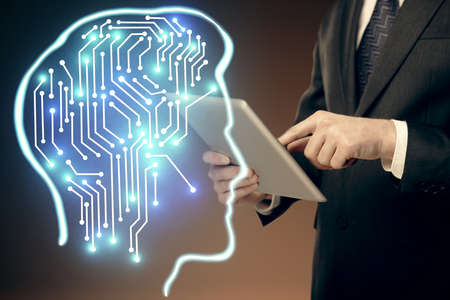Double exposure of man's hand holding and using a digital device and brain hologram drawing. Data...