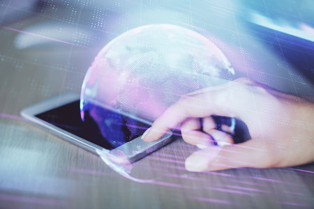 Double exposure of tech icon hologram and woman holding and using a mobile device. Technology concept.の写真素材