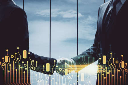 Double exposure of data theme hologram and handshake of two men. Partnership in IT industry concept.