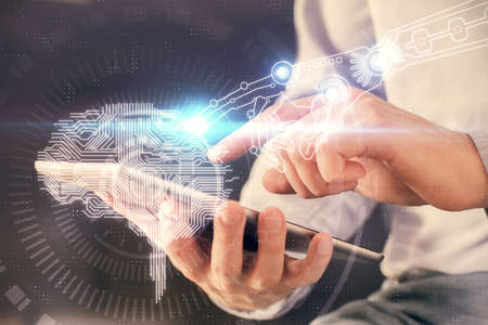 Double exposure of man's hand holding and using a digital device and brain hologram drawing. Data concept.の写真素材