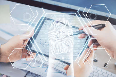 Double exposure of man's hands holding and using a digital device and fingerprint hologram drawing....