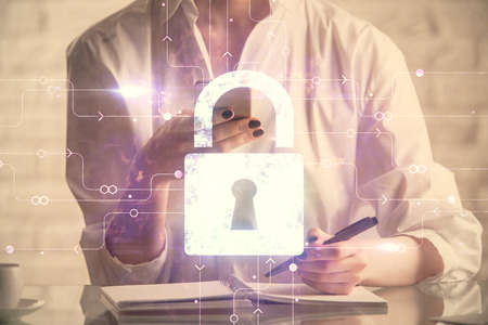 Double exposure of lock sketch hologram and woman holding and using a mobile device. Security iT...