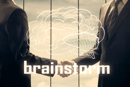 Multi exposure of creative drawing hologram and handshake of two men. Start up conceptの写真素材