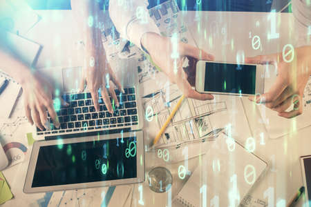 Double exposure of man and woman working together and data theme hologram drawing. Computer...