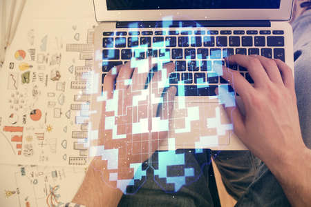 Multi exposure of man's hands typing over computer keyboard and data theme hologram drawing. Top...