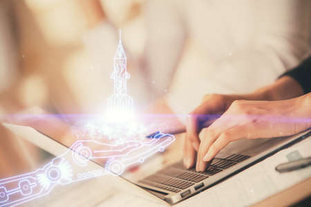 Double exposure of woman hands typing on computer and creative drawing. Start up concept.の写真素材