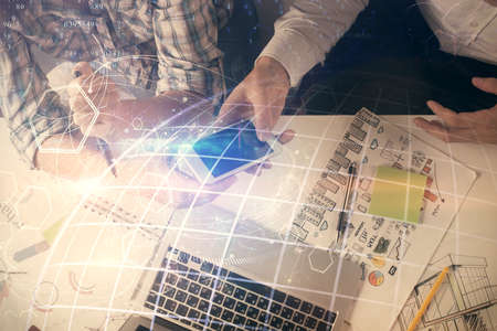 Double exposure of map drawing and man and woman working together holding and using a mobile device. Planet tech concept.の写真素材