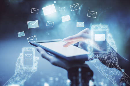Double exposure of envelop icon hologram and woman holding and using a mobile device. E-mail concept.の写真素材