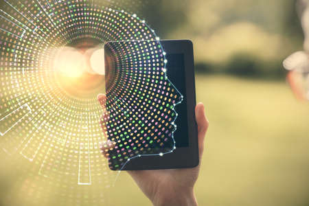 Double exposure of brain sketch hologram and woman holding and using a mobile device.の写真素材