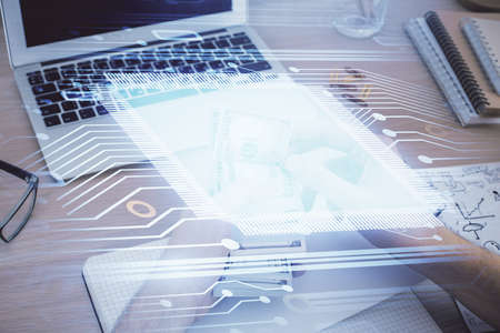Multi exposure of technology drawing hologram and us dollars bills and man hands. Data concept