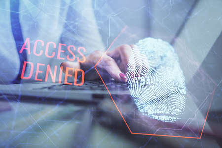 Double exposure of woman hands typing on computer and fingerprint drawing. Security concept.