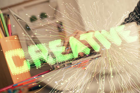 Double exposure of woman hands typing on computer and creative drawing. Start up concept.の写真素材
