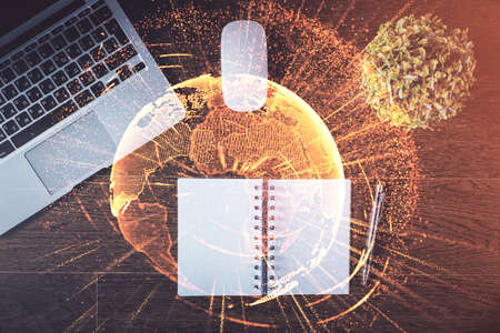 Social network hologram drawings over computer on the desktop background. Top view. Double exposure.の写真素材