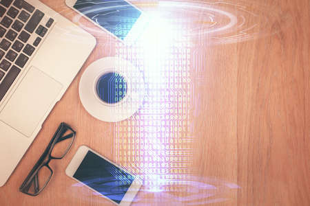 Double exposure of technology theme drawing over work table desktop. Top view. Global data analysis...