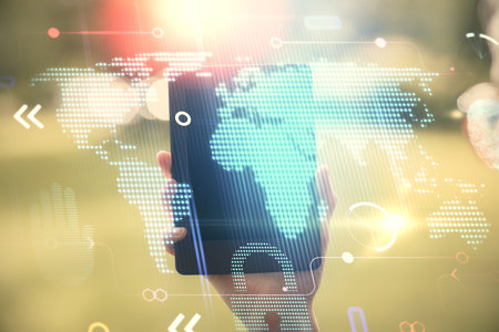 Double exposure of map sketch hologram and woman holding and using a mobile device.