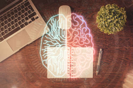 Double exposure of brain drawing hologram over topview work table background with computer. Concept...