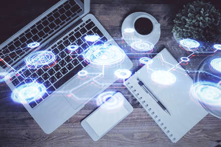 Social network hologram drawings over computer on the desktop background. Top view. Double exposure.の写真素材