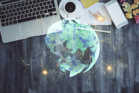 Social network hologram drawings over computer on the desktop background. Top view. Double exposure.の写真素材