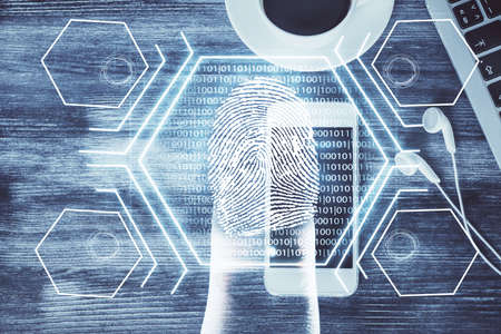 Double exposure of finger print over table with phone. Top view. Concept of mobile security.