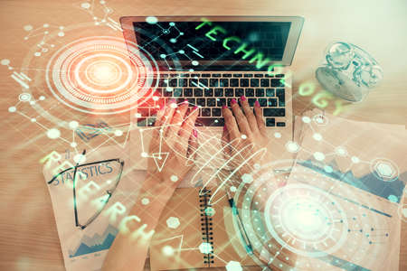 Double exposure of woman hands working on computer and data theme hologram drawing. Top View. Technology concept.の写真素材