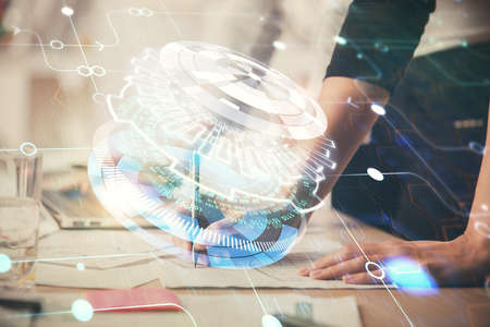 Double exposure of woman hands working on computer and data theme hologram drawing. Tech concept.